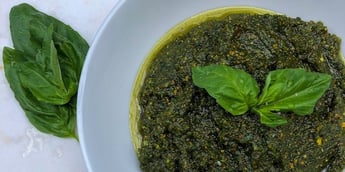 Trifecta Classic Pesto Sauce Recipe served on a white bowl topped with fresh basil